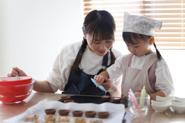 Parents and children making sweets
