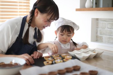 Parents and children making sweets