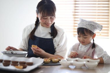 Parents and children making sweets