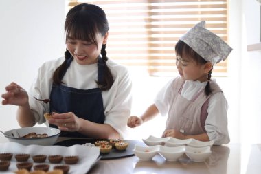 Parents and children making sweets