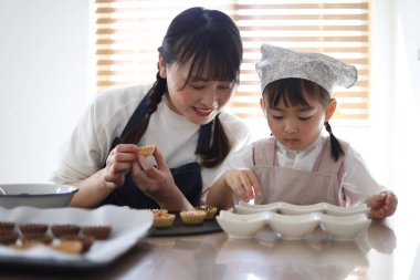 Parents and children making sweets