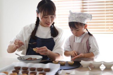 Parents and children making sweets