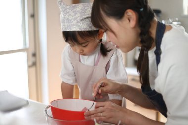 Parents and children making sweets