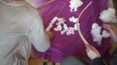 Pamukla pamuk atan bir kadın.