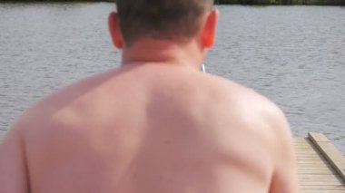 Yaz tatilindeki çocuk ya da dağ gölündeki tahta kaldırımda tatil koşusu, sıcağın altında serinlemek için soğuk tatlı suya atlamak, doğal yaşam tarzı..