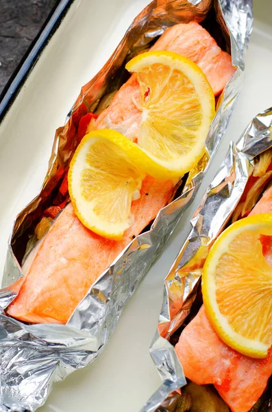 Baked Salmon in Foil, Cooked Fish with Vegetables in a baking dish, Healthy Eating