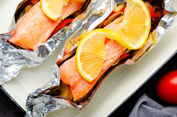 Baked Salmon in Foil, Cooked Fish with Vegetables in a baking dish, Healthy Eating