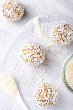 Coconut Vegan Sweets, Delicious Candy Balls, Healthy Candies on grey bright background