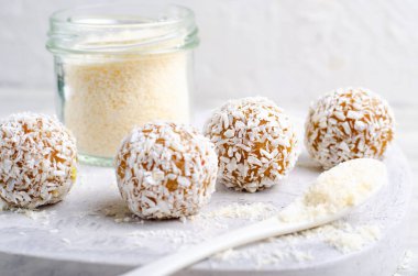 Coconut Vegan Sweets, Delicious Candy Balls, Healthy Candies on grey bright background