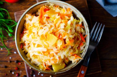 Sauerkraut, Shredded cabbage, apples, and carrots on dark rustic background, Healthy Eating, Fermented Food