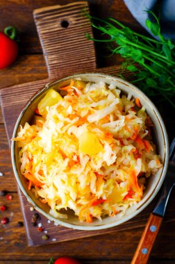 Sauerkraut, Shredded cabbage, apples, and carrots on dark rustic background, Healthy Eating, Fermented Food