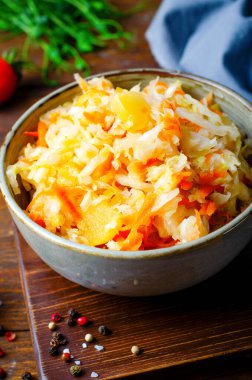 Sauerkraut, Shredded cabbage, apples, and carrots on dark rustic background, Healthy Eating, Fermented Food