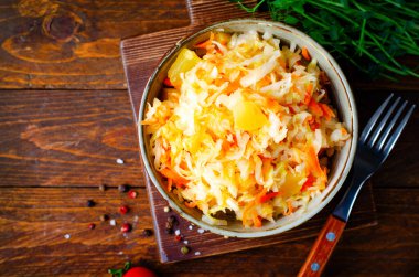 Sauerkraut, Shredded cabbage, apples, and carrots on dark rustic background, Healthy Eating, Fermented Food