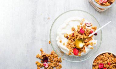 Granola with Yogurt in a Boal, Healthy Breakfast, Muesli with Dried Berries on Bright Background