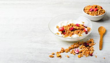 Granola with Yogurt in a Boal, Healthy Breakfast, Muesli with Dried Berries on Bright Background
