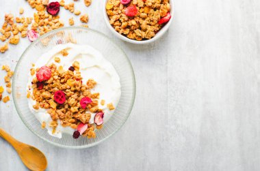 Granola with Yogurt in a Boal, Healthy Breakfast, Muesli with Dried Berries on Bright Background