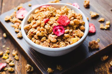 Granola with Dried Berries on Dark Wooden Background, Healthy Breakfast