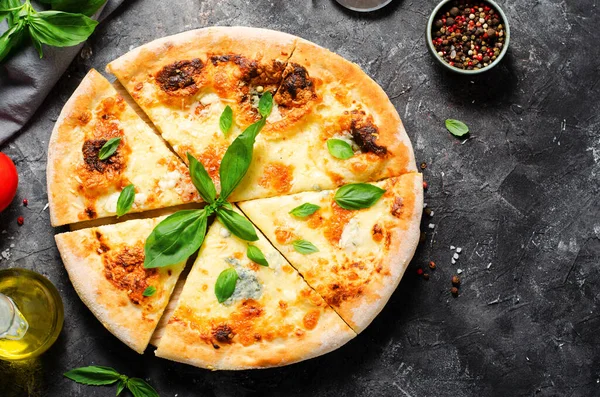 stock image Four Cheese Pizza on Dark Background, Freshly Baked Pizza and Basil Leaves