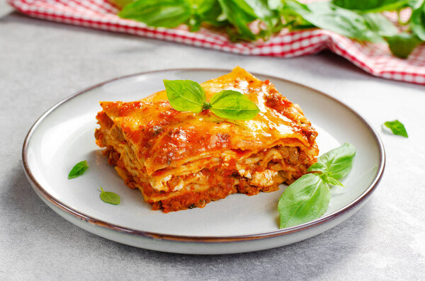 Delicious Homemade Lasagna with Bolognese Sauce on Bright Background, Italian Cuisine, Traditional Baked Lasagna