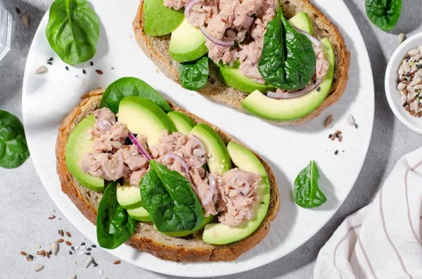 stock image Tuna Avocado Toasts, Healthy Snack or Breakfast on Bright Concrete Background