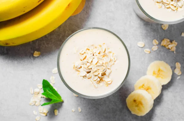 Banana Smoothie with Oats, Healthy Food, Vegan or Vegetarian Diet Food Concept, Grey Concrete Background