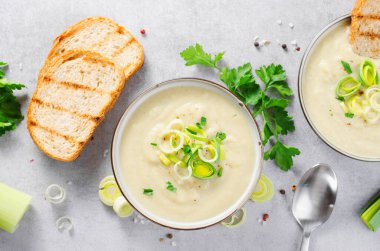 Leek Soup, Comfort Meal, Potato and Leek Creamy Soup, Vegetarian Food on Bright Grey Background clipart