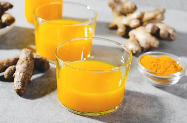 采购产品姜黄射击 健康的饮料与姜黄和香料 Jamu果汁 免疫助推器饮料在明亮的灰色背景 — 图库照片