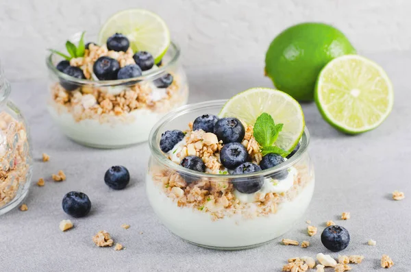 stock image Crunchy Granola with Yogurt, Lime and Blueberries, Healthy Snack or Breakfast on Bright Background