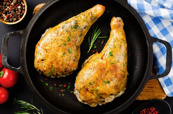 stock image Baked Stuffed Chicken Legs in a Pan on Dark Black Background