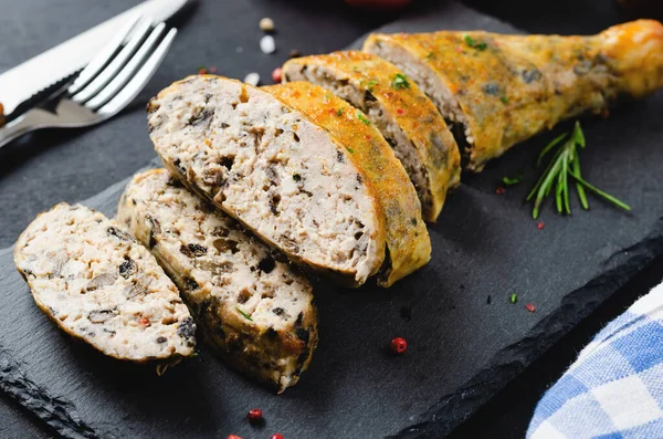 stock image Baked Stuffed Chicken Legs on a Black Cutting Board, Dark Background