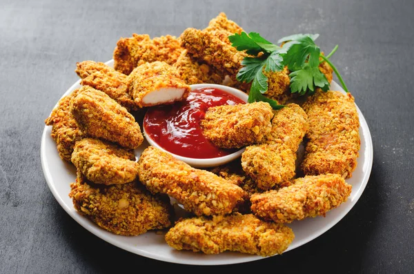 Delicious Crispy Fried Breaded Chicken Breast Strips with Ketchup on Dark Background, Chicken Fingers