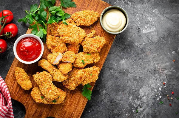 stock image Delicious Crispy Fried Breaded Chicken Breast Strips with Ketchup on Dark Background, Chicken Fingers