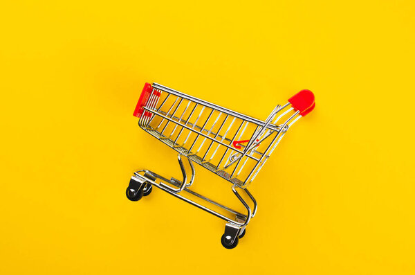 Shopping Cart or Trolley on Yellow Background, Shopping, Sale Concept