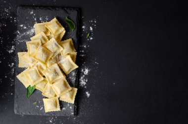 Unlu çiğ Ravioli ve Karanlık Arkaplanda Basil, Taze İtalyan Ravioli