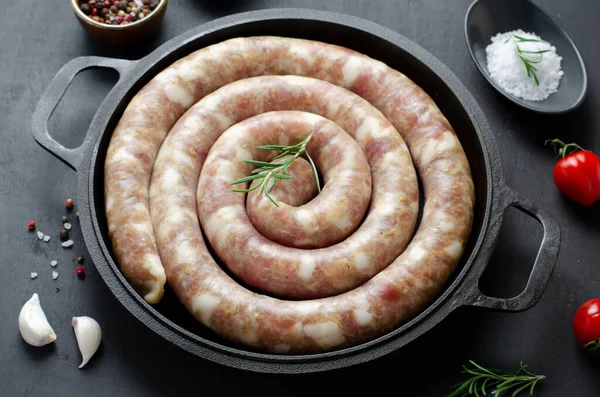 stock image Traditional Raw Spiral Sausages, Meat Round Sausages with Spices on Dark Background