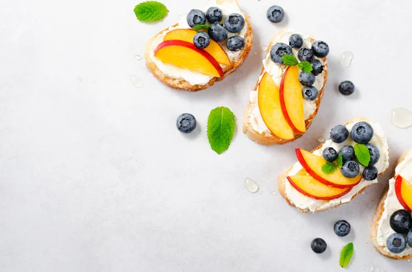 stock image Homemade Toast with Blueberry, Peach and Cream Cheese, Delicious Snack or Breakfast on Bright Background