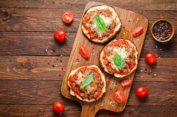 stock image Eggplant Pizza with Tomato Sauce, Minced Meat, Mozzarella and Basil, Mini Pizza over Rustic Background