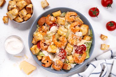 Parmesan peynirli, marullu, soslu ve kıtır kıtırlı karides Sezar Salatası.