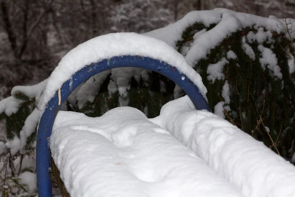 stock image Bench in the snow against the Christmas trees, Kharkiv, Ukraine