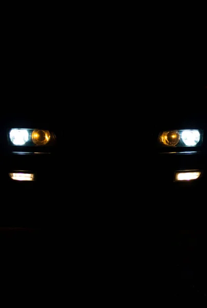 暗闇から輝くヨーロッパ車のヘッドライト — ストック写真