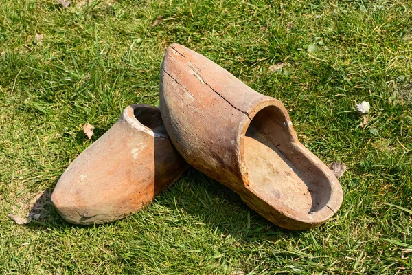Ancient vintage wooden shoes, Top portrait of a pair of wooden shoes on the grass