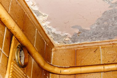 Ragged ceiling in an apartment after a long period of careless maintenance
