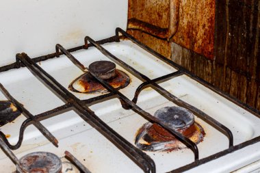 Kitchen tiles and pipes covered in grease. Dirty kitchen after sloppy residents