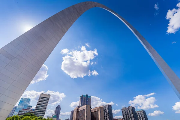 A group of buildings as seen through the Gateway Arch in St Louis Missouri.
