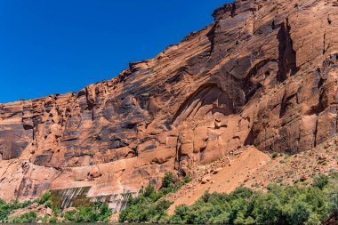 A view of naturally formed arches on canyon wall on Colorado River in Glen Canyon clipart