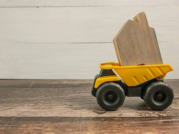 The yellow truck  and wood home for building or construction concept