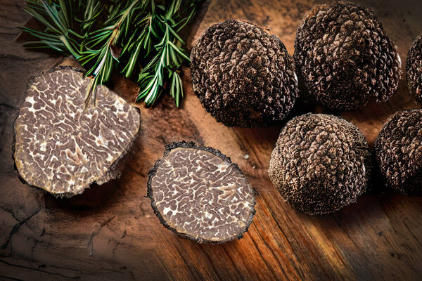 Truffle mushrooms have a dark, knobby exterior and a soft, fragrant interior. They grow symbiotically with the roots of certain trees, such as oak and hazelnut, and are typically harvested using specially trained dogs or pigs