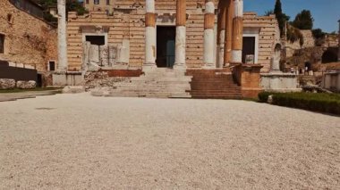 BRESCIA, İtalya, 20 Temmuz 2024 - Yıpranmış mermer sütunlar ve taş başkentler Tempio Capitolino kalıntıları, Brescia, Lombardy, İtalya 'nın kutsal bölgesini işaret ediyor