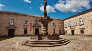 BRAGA, Portugal, 17 June 2025 - Largo do Paco Square features arcaded palace wings stone fountain and shaded seating inviting visitors in Braga, Portugal