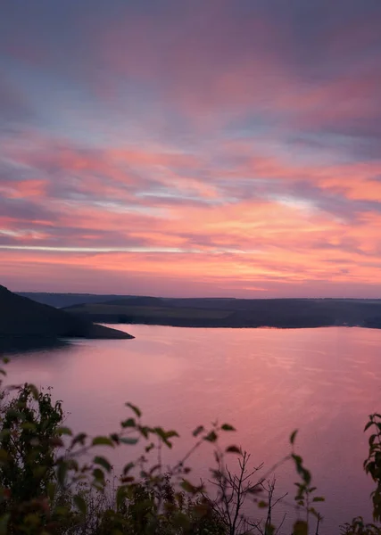 Sunset view of Bakota Bay with pink sky on dusk. Located on place of old village that was flooded after big hydroelectricity dam was built on Dniester river. Khmelnytskyi region, Ukraine.